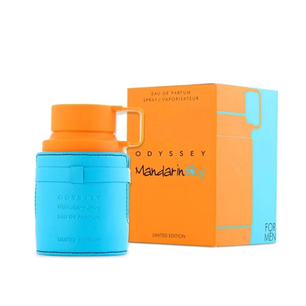 Se muestra un frasco de ARMAF ODDYSEY MANDARIN SKY de DarlynS Perfumería y Accesorios, con tapón naranja y funda azul, junto a su caja de marca naranja y azul etiquetada como Edición Limitada.