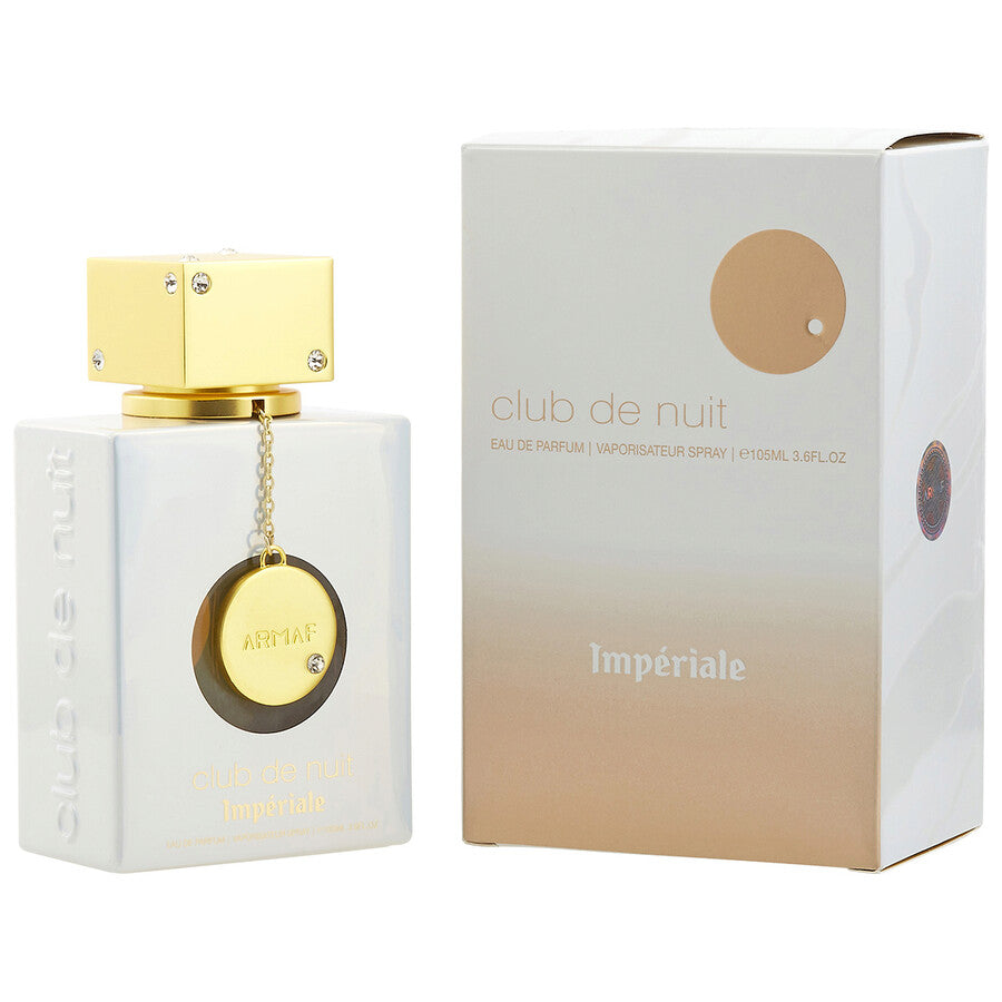 Un frasco blanco y dorado de 3,6 oz de ARMAF CLUB DE NUIT IMPERIALE EDP para mujer de DarlynS Perfumería y Accesorios se muestra con su caja a juego, con un tapón dorado, un colgante redondo y un elegante texto dorado tanto en el frasco como en el envase.